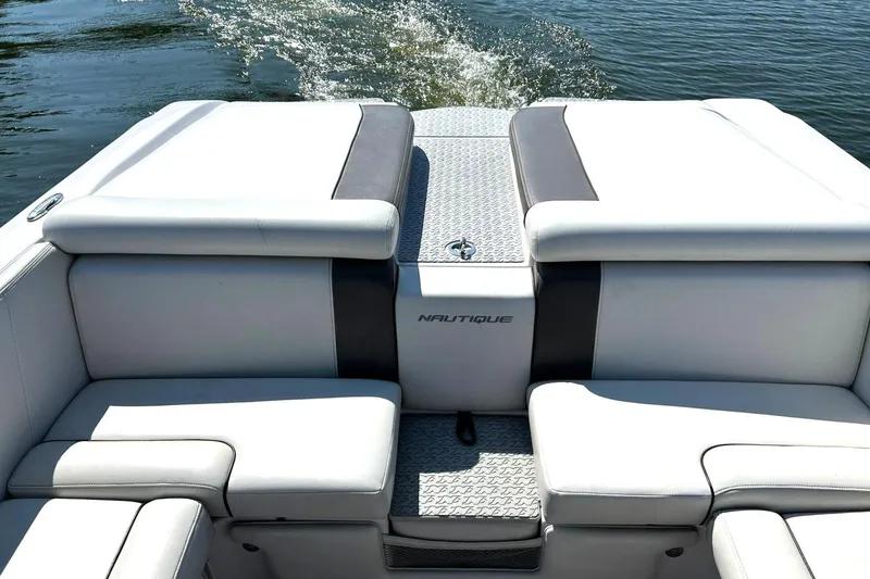 Slide: The Image of 2008 Air Nautique Crossover 236 boat interior with cushioned seating and water view. - 4