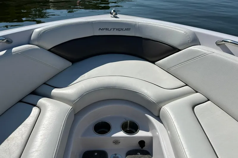 Slide: The Image of 2008 Air Nautique Crossover 236 boat interior with cushioned seating and cup holders. - 42