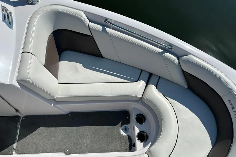Slide: The Image of 2008 Air Nautique Crossover 236 boat interior with white cushioned seating and cup holders. - 44
