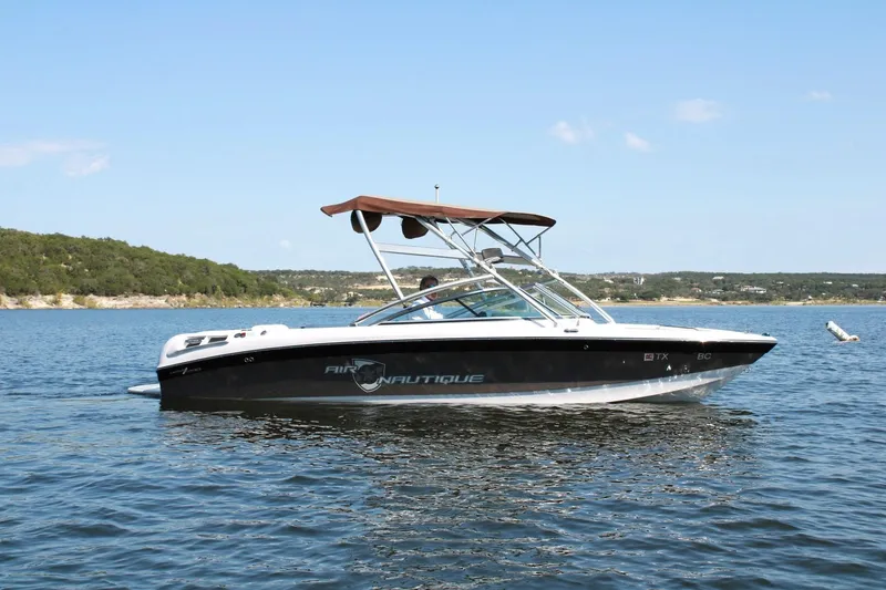 Slide: The Image of 2008 Air Nautique Crossover 236 boat on a lake with scenic background. - 8