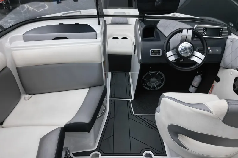 Slide: The Image of 2016 Tigé R20 boat interior with modern steering wheel and seating. - 12