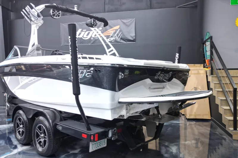 Slide: The Image of 2016 Tigé R20 boat on trailer in showroom, rear view. - 15