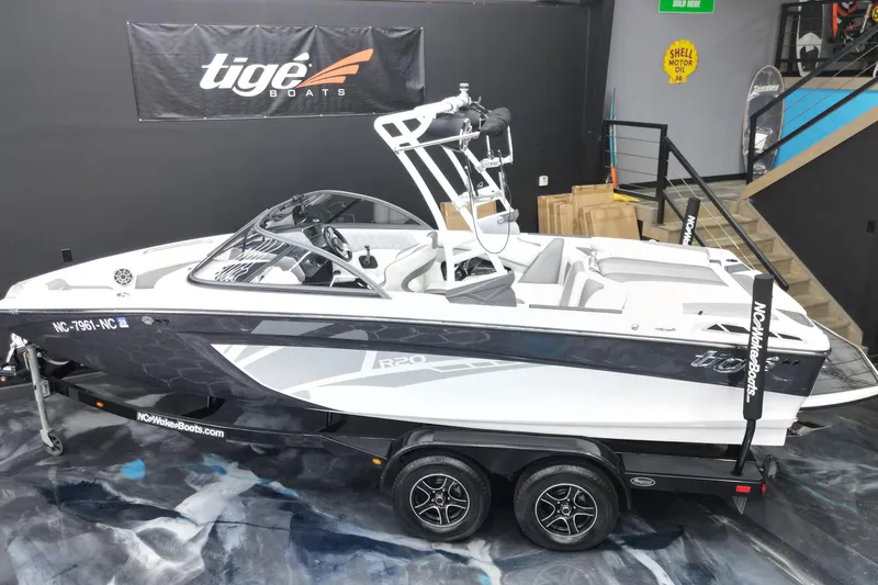 Slide: The Image of 2016 Tigé R20 boat on trailer in showroom, featuring sleek design and modern interior. - 4