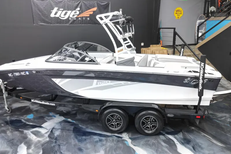 Slide: The Image of 2016 Tigé R20 boat on trailer in showroom, featuring sleek design and modern features. - 5