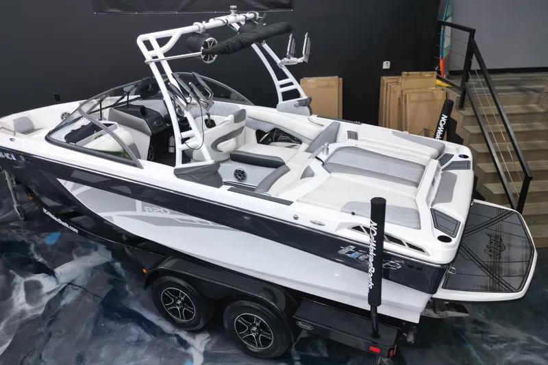 Slide: The Image of 2016 Tigé R20 boat with sleek design, white and gray interior, on a trailer indoors. - 6