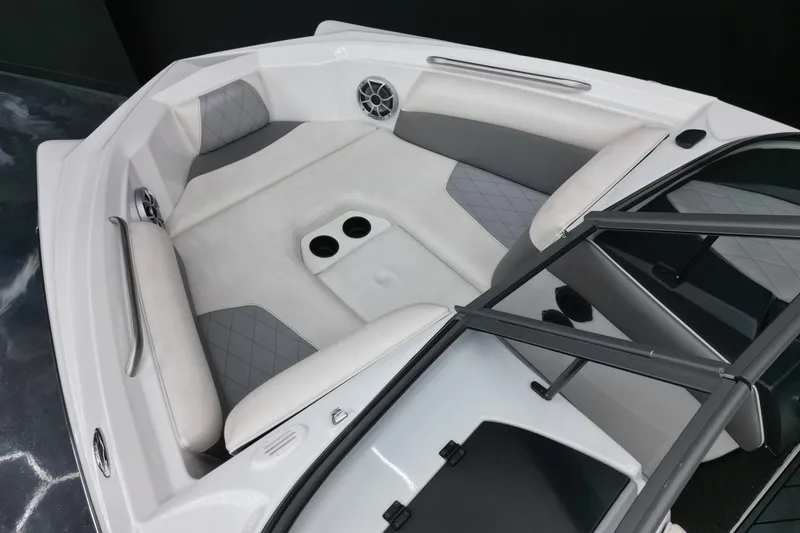 Slide: The Image of 2016 Tigé R20 boat interior with gray and white seating, cup holders, and speaker. - 7