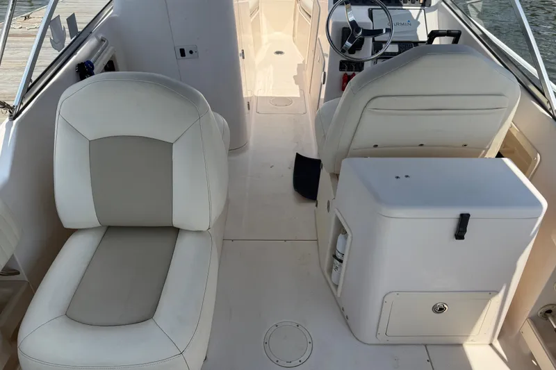 Slide: The Image of 2008 Grady-White Tournament 275 boat with seating, parked under a cloudy sky. - 11