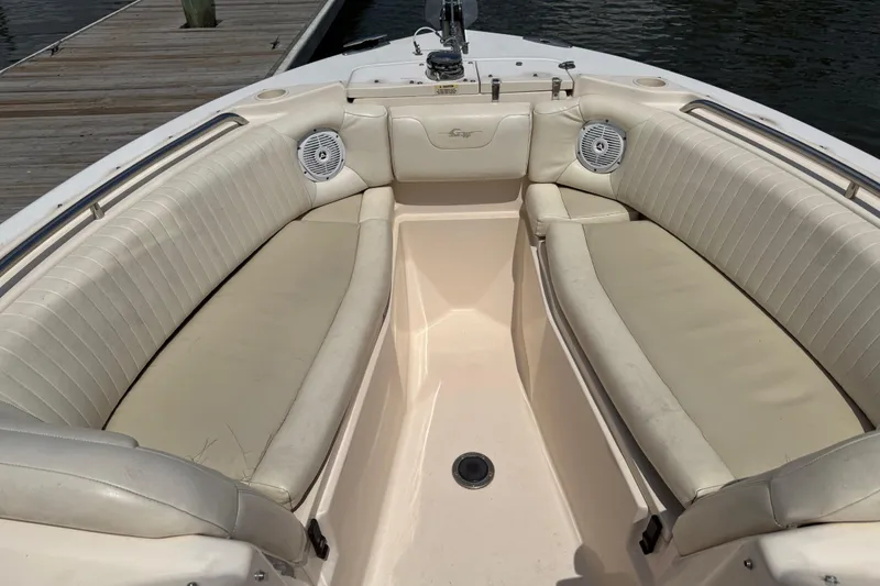 Slide: The Image of 2008 Grady-White Tournament 275 boat with spacious seating and speakers, parked outdoors. - 12