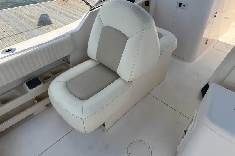 Slide: The Image of 2008 Grady-White Tournament 275 boat cockpit with steering wheel and comfortable seating. - 17