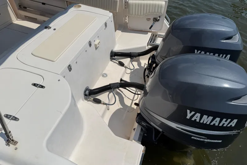 Slide: The Image of 2008 Grady-White Tournament 275 boat bathroom interior with toilet and storage nets. - 28