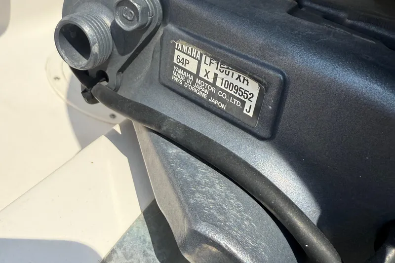 Slide: The Image of 2008 Grady-White Tournament 275 boat with open storage compartments and dual engines. - 29