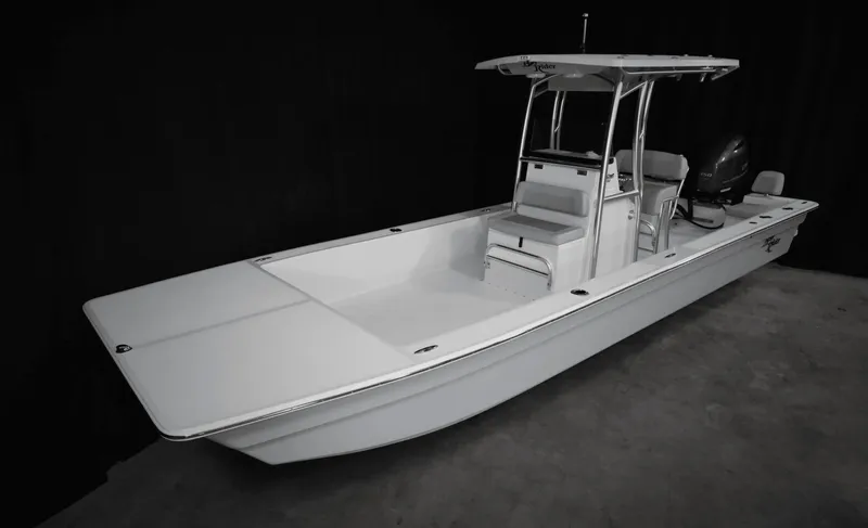 Slide: The Image of 2025 KenCraft 2460 Bay Rider Skiff, white, center console, outboard motor, spacious deck. - 2