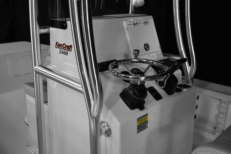 Slide: The Image of KenCraft 2460 Bay Rider Skiff 2025 model boat console with steering wheel and controls. - 7