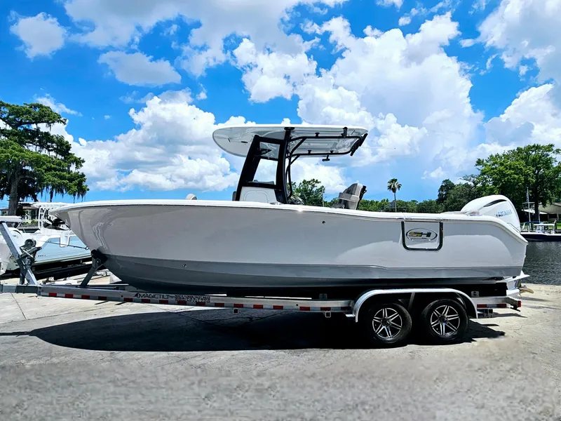 Slide: The Image of 2025 Sea Hunt Ultra 255 SE boat on trailer under a bright blue sky. - 44