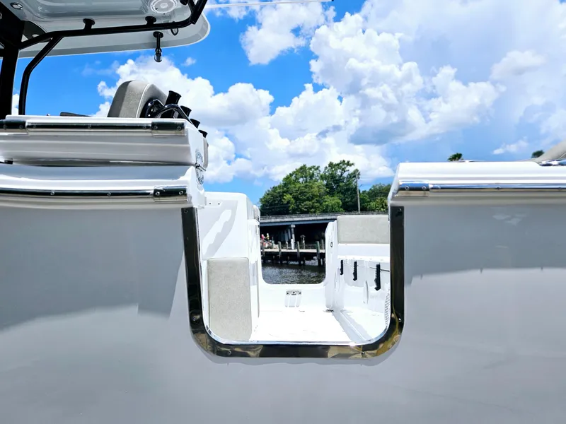 Slide: The Image of 2025 Sea Hunt Ultra 255 SE boat with open side door, blue sky background. - 46