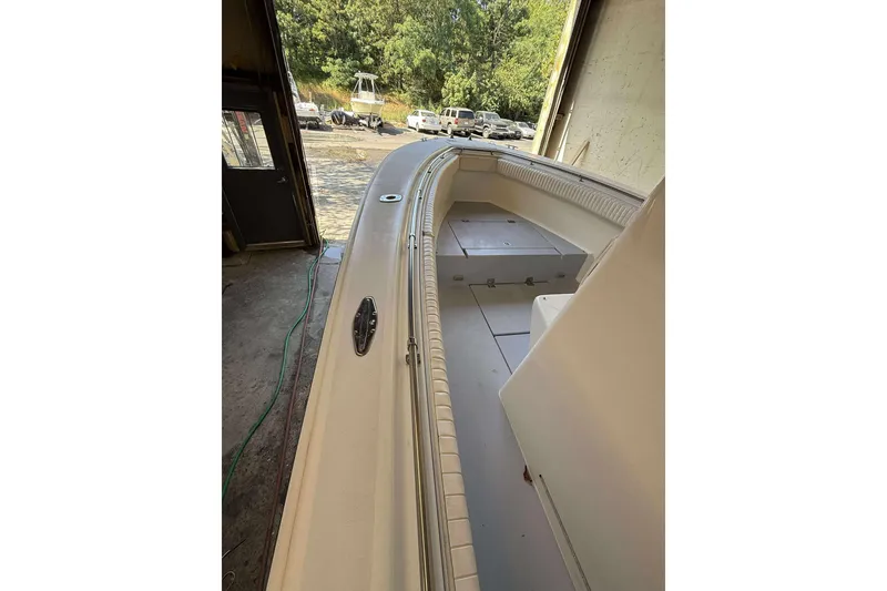 Slide: The Image of 1996 Silverhawk 24 boat interior with seating, docked in a garage. - 10