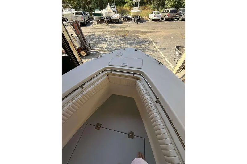 Slide: The Image of Interior view of 1996 Silverhawk 24 boat with cushioned seating and storage compartment. - 11