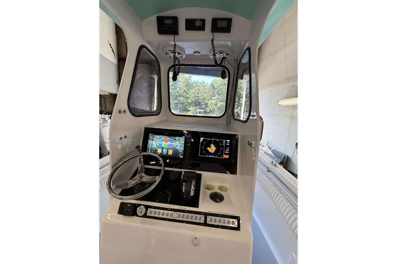 Slide: The Image of Interior view of a 1996 Silverhawk 24 boat cockpit with modern navigation equipment. - 4
