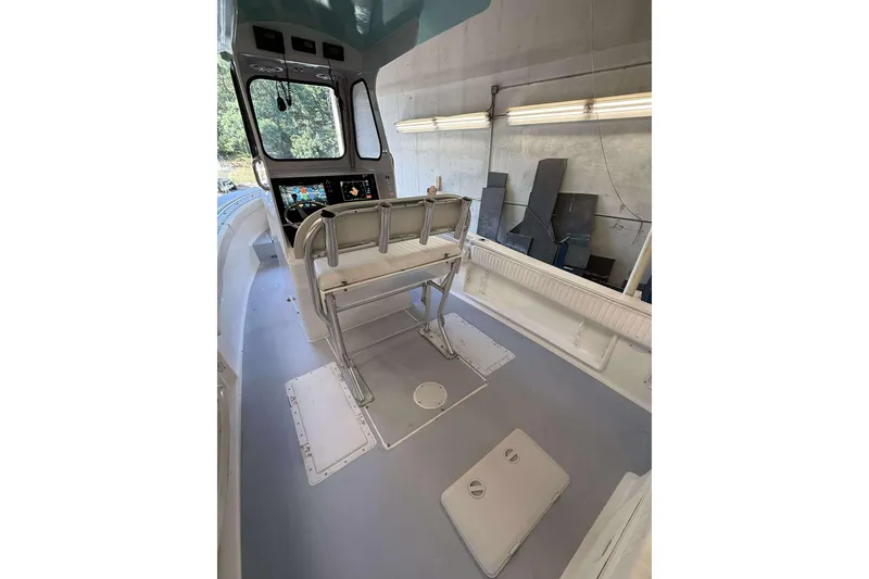 Slide: The Image of Interior of a 1996 Silverhawk 24 boat with modern controls and seating. - 7