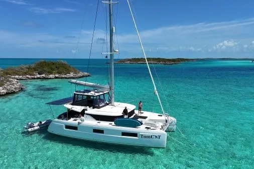 The Image of 2023 Lagoon 46 catamaran sailing in clear turquoise waters near tropical islands. - 0