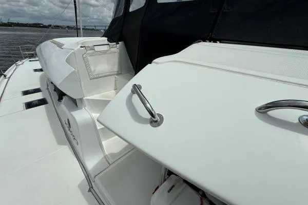 Slide: The Image of 2023 Lagoon 46 yacht deck with sleek white design and stainless steel handles. - 12