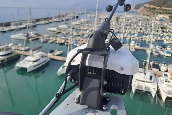 Slide: The Image of Rooftop view of a 2023 Lagoon 46 yacht in a marina, surrounded by boats. - 17
