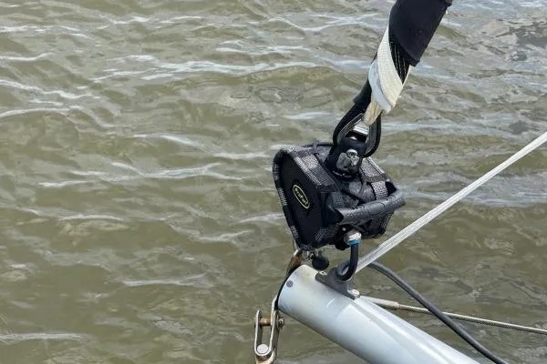 Slide: The Image of Close-up of a 2023 Lagoon 46 sailboat rigging detail over water. - 18