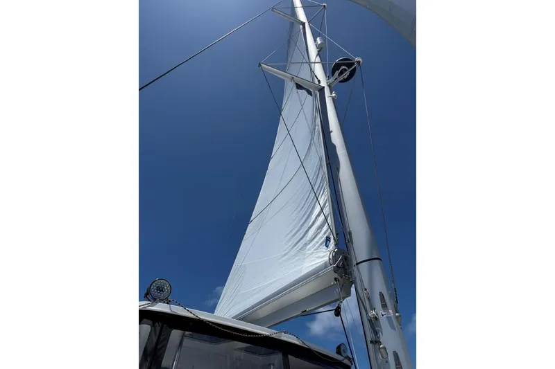 Slide: The Image of Sailing mast and sail of 2023 Lagoon 46 catamaran against clear blue sky. - 19