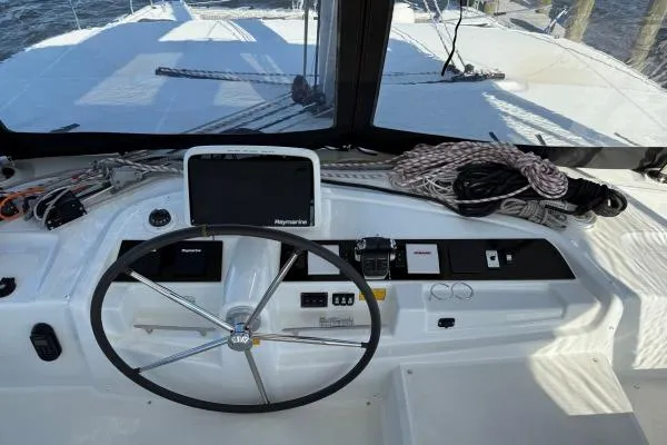 Slide: The Image of 2023 Lagoon 46 yacht helm with navigation equipment and steering wheel. - 20