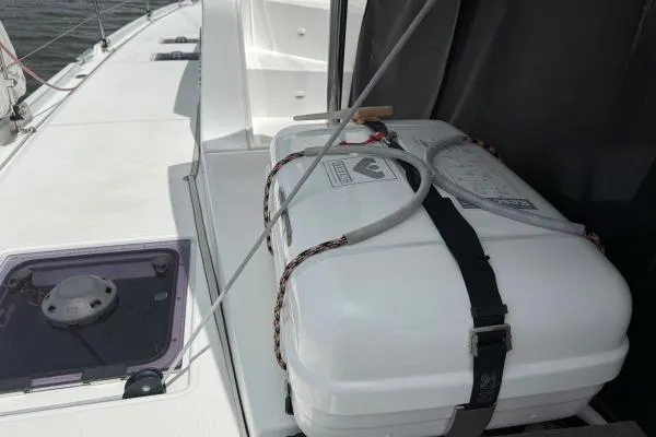 Slide: The Image of 2023 Lagoon 46 yacht deck with secured white storage box. - 22