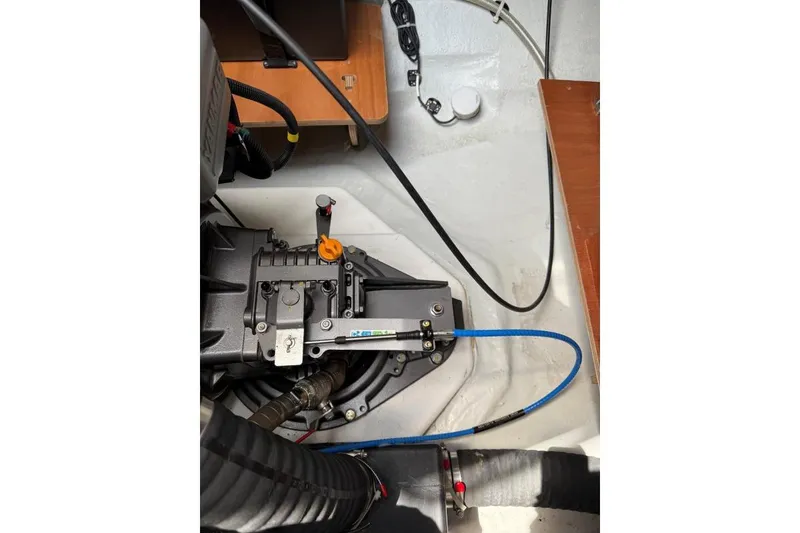 Slide: The Image of Engine compartment of 2023 Lagoon 46 yacht, showcasing mechanical components and wiring. - 26