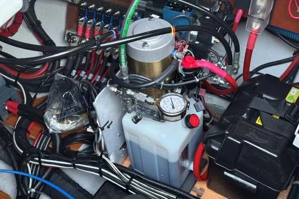 Slide: The Image of Engine compartment of 2023 Lagoon 46 yacht with wiring and hydraulic components. - 31