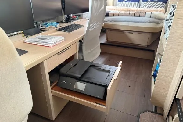 Slide: The Image of Modern office setup inside a 2023 Lagoon 46 yacht with printer and dual monitors. - 4