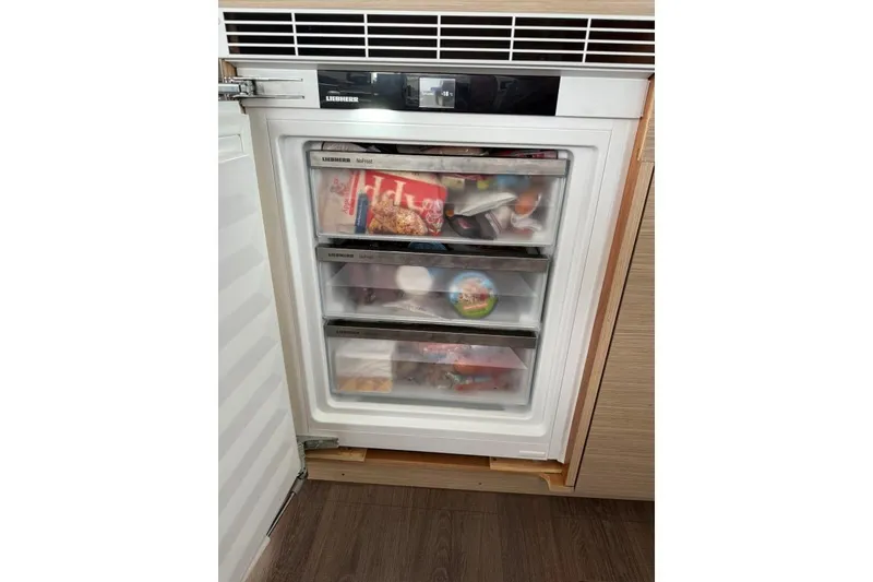Slide: The Image of Built-in Liebherr freezer with three drawers, stocked with various frozen foods. - 9