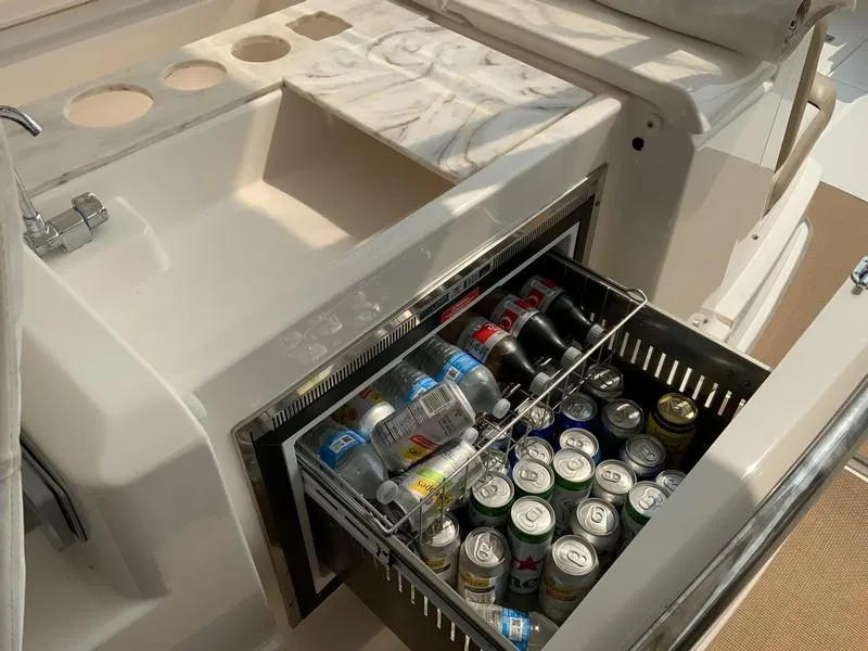 Slide: The Image of Tiara Yachts 36, 2013 model, featuring a built-in beverage cooler with assorted drinks. - 17