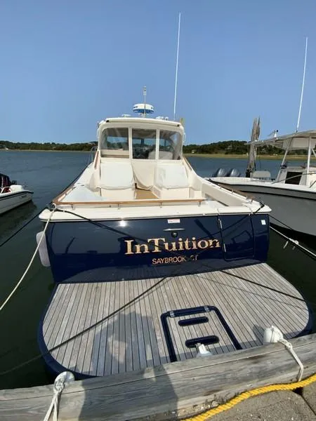 Slide: The Image of 2013 Tiara Yachts 36 docked, rear view with "InTuition" name visible. - 3