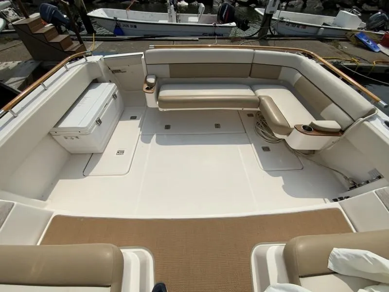 Slide: The Image of Spacious deck of 2013 Tiara Yachts 36 with beige seating and storage. - 7