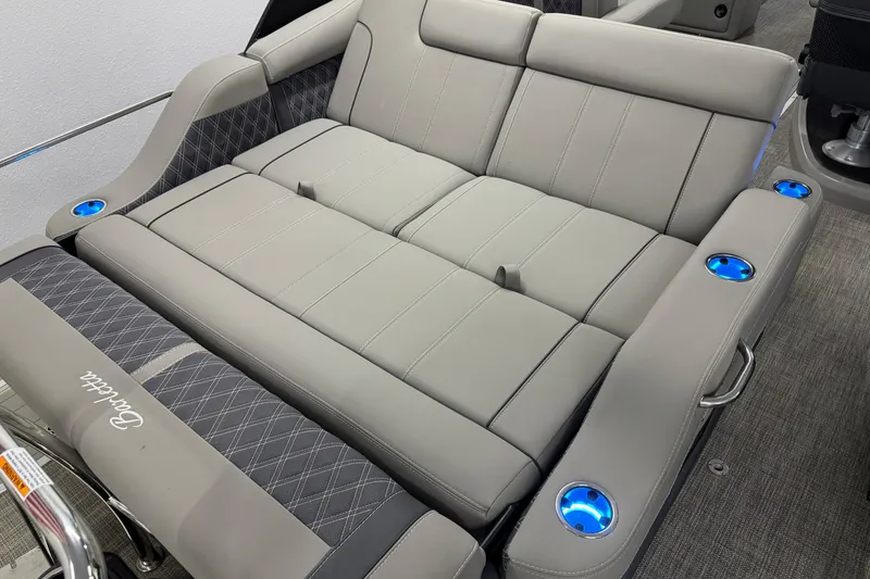 Slide: The Image of 2023 Barletta LUSSO 25U boat interior with luxurious gray seating and illuminated cup holders. - 12