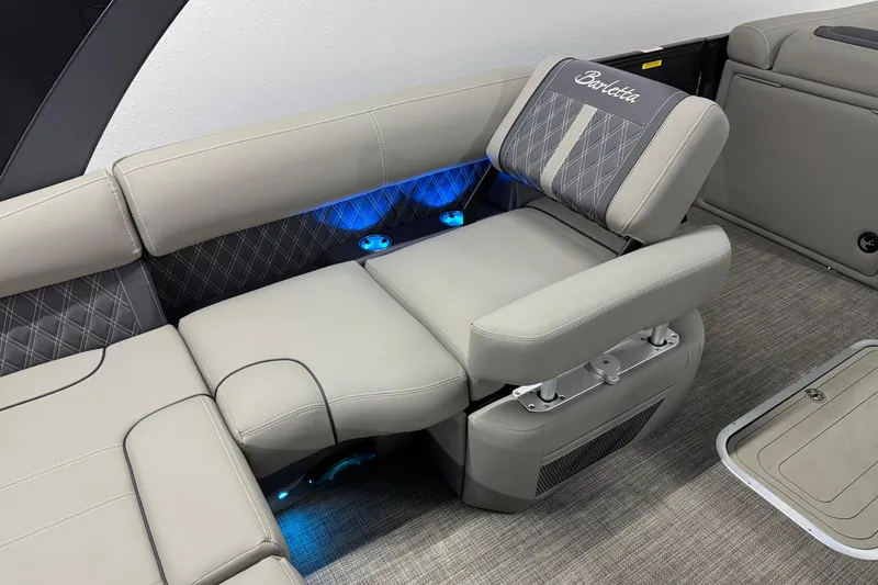 Slide: The Image of 2023 Barletta LUSSO 25U boat interior with luxurious seating and ambient blue lighting. - 14