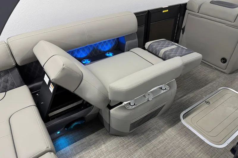 Slide: The Image of 2023 Barletta LUSSO 25U boat interior with adjustable seating and blue LED lighting. - 18