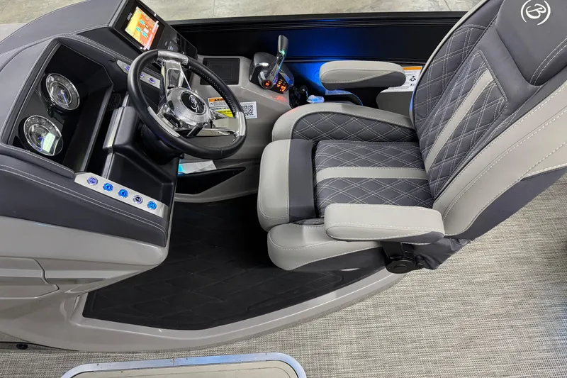 Slide: The Image of 2023 Barletta LUSSO 25U boat interior with steering wheel and luxury seating. - 22