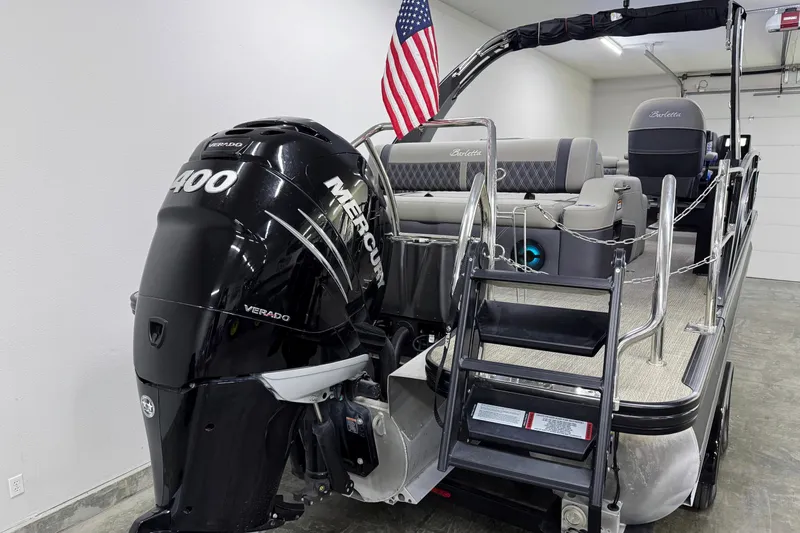 Slide: The Image of 2023 Barletta LUSSO 25U pontoon boat with Mercury 400 Verado engine and American flag. - 4