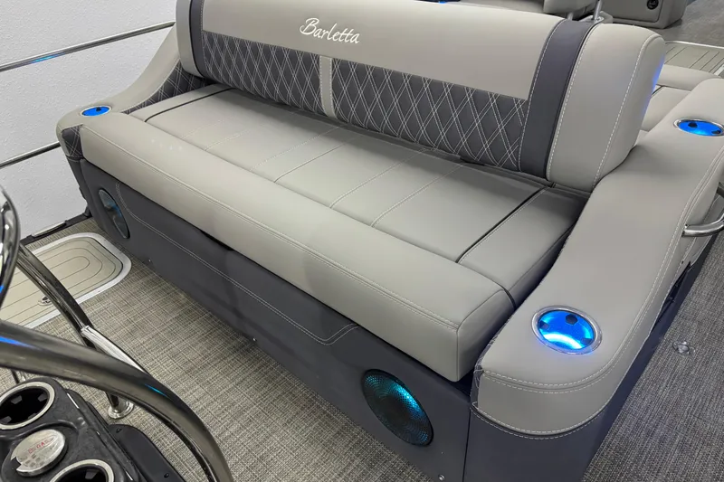Slide: The Image of 2023 Barletta LUSSO 25U boat interior with gray seating and blue LED cup holders. - 7