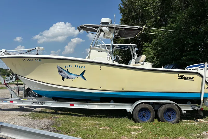 Slide: The Image of 2008 Mako 264 Center Console boat on trailer, featuring "Blue Shark" graphic. - 1