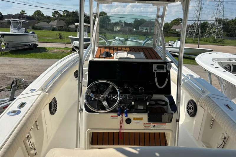 Slide: The Image of 2008 Mako 264 Center Console boat interior with steering wheel and control panel. - 4