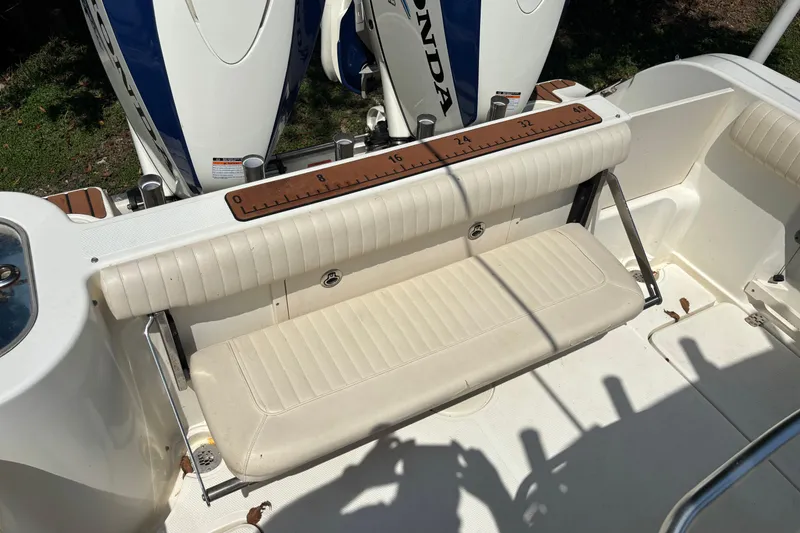 Slide: The Image of 2008 Mako 264 Center Console boat with Honda engines and foldable bench seat. - 8