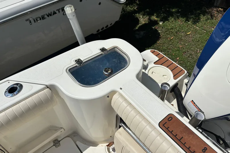 Slide: The Image of 2008 Mako 264 Center Console boat interior with seating and storage compartments. - 9