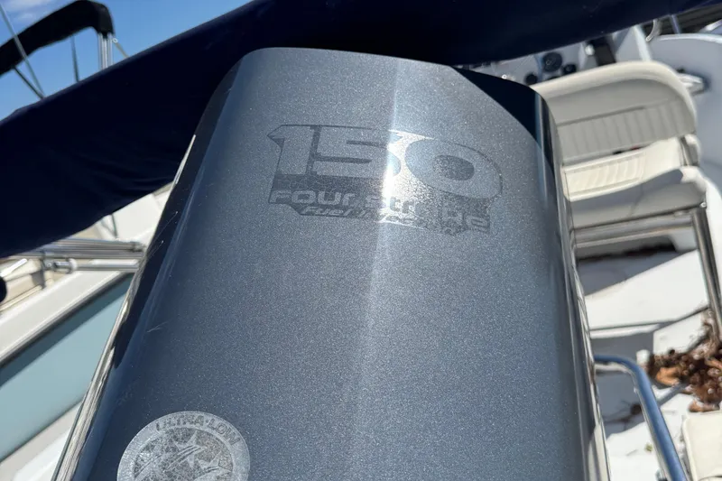 Slide: The Image of Close-up of a 150 horsepower four-stroke engine on a 1997 Boston Whaler Outrage 17 boat. - 6