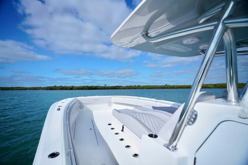 Slide: The Image of 2023 SeaHunter 41 CTS boat on calm water under a clear blue sky. - 12