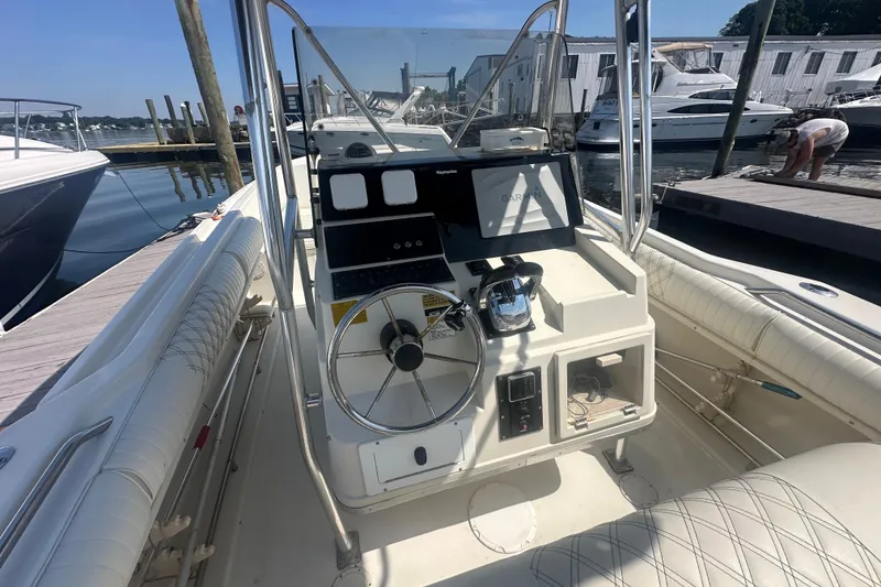 Slide: The Image of 1994 Donzi 3300 Center Console boat interior with steering wheel and navigation equipment. - 4
